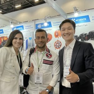 ECvents EC Motor Shop booth at a trade show with smiling attendees showcasing industrial motor solutions.