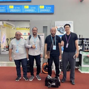 ECvents EC Motor Shop team visiting trade show booth displaying industrial motors and equipment for automation solutions.