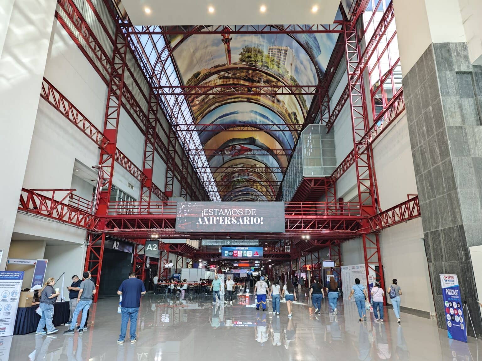 ECvents industrial exhibition hall with red steel framework and high ceiling artwork, showcasing a modern event space ideal for trade shows, conferences, and corporate gatherings.